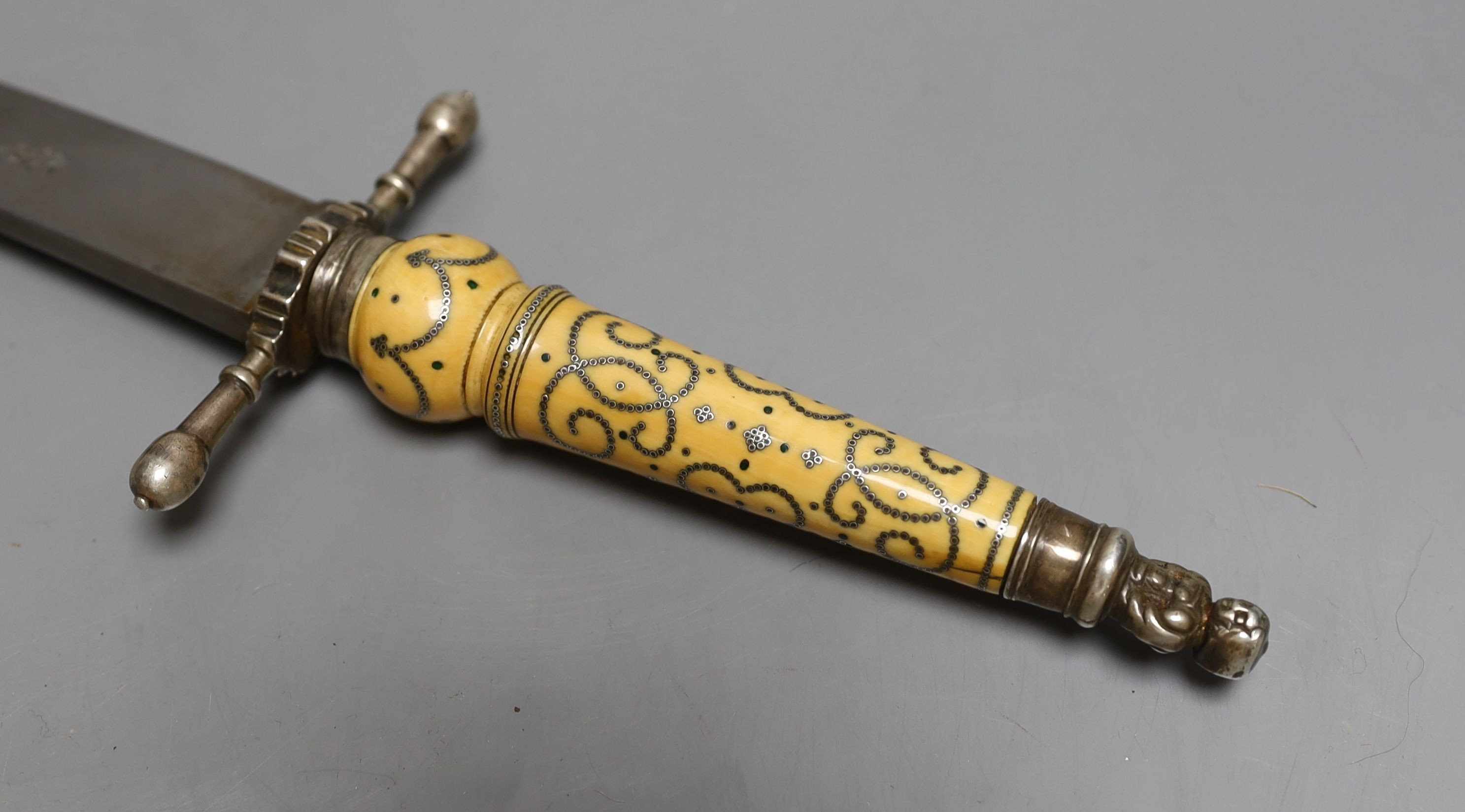 A Fine English Charles II officer’s plug bayonet, blade 30cms struck with maker’s mark, silver mounts including pommel formed as a pair of addorsed angels, turned ivory grip inlaid with green stained ivory pellets and si